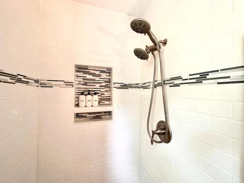 a shower with a shower head in a bathroom at Cozy 3 bdr Retreat in a Prime location in Streamwood
