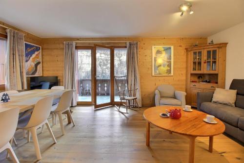 a living room with a table and a couch at Monteilly C26 Next To Cable Car in Champéry