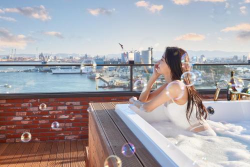 a woman sitting in a bath tub on a ship at Browndot Terrace Pohang Passenger Terminal in Pohang