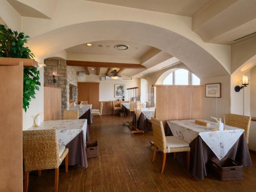 a dining room with tables and chairs and an archway at Sabae City Hotel in Sabae