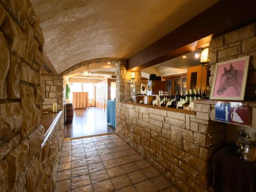 a room with a stone wall and a bar at Sabae City Hotel in Sabae
