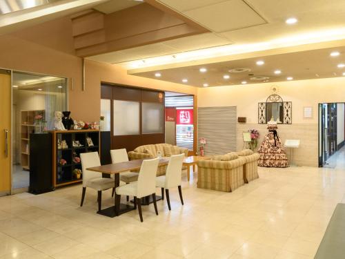 a store with a table and chairs in a room at Sabae City Hotel in Sabae