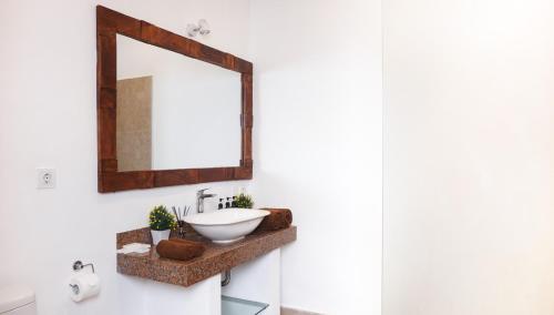 a bathroom with a sink and a mirror at Suite by the Sea Apartment Seminyak in Seminyak