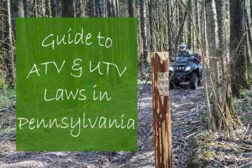 a sign in the woods with a person on a atv at Huge villa in the hearth of Poconos near all. in Long Pond
