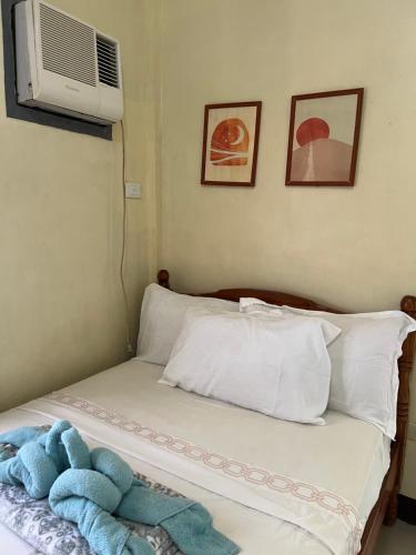 a bed with a blue teddy bear sitting on it at C View Resort in Sipalay