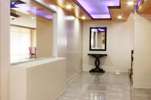 a room with a mirror and a table on a wall at Hotel Villa Lafayette in Quito