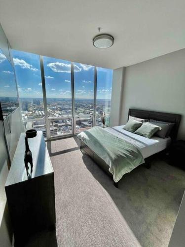 a bedroom with a cat sitting on a table in front of a window at Penthouse In South Loop Chicago in Chicago