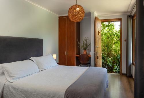 a bedroom with a large bed and a window at Callihue Lodge in Santa Cruz