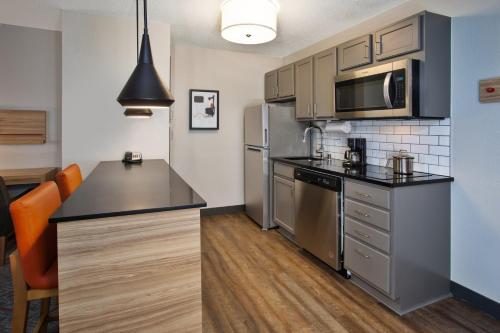 a kitchen with stainless steel appliances and a counter top at Candlewood Suites Kenosha - Pleasant Prairie by IHG in Pleasant Prairie