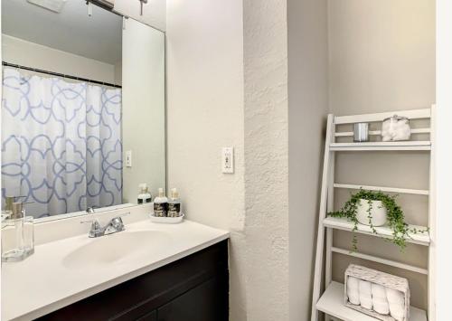 a bathroom with a sink and a mirror at Charming Lakeview Retreat II only 5 Min Sea World in Orlando