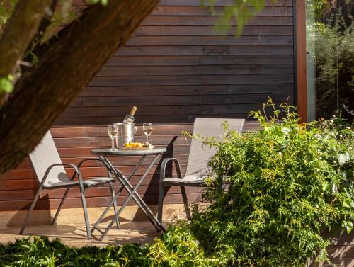a table with two chairs and a bottle of wine at Callihue Lodge in Santa Cruz