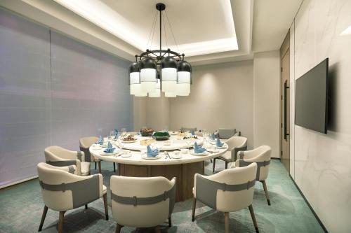 a dining room with a table and chairs at Sheraton Guangzhou Hotel in Guangzhou