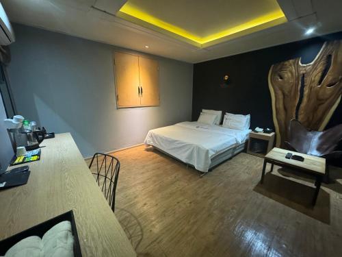 a hotel room with a bed and a table and a table at Urban Nest Hotel in Seoul