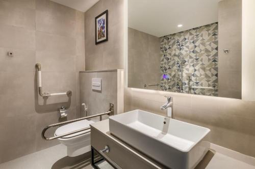 a bathroom with a sink and a toilet at Holiday Inn Express Kathmandu Naxal, an IHG Hotel in Kathmandu
