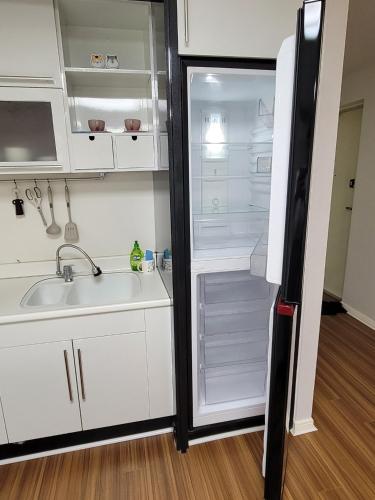 a kitchen with white cabinets and a refrigerator at White Stay in Seoul