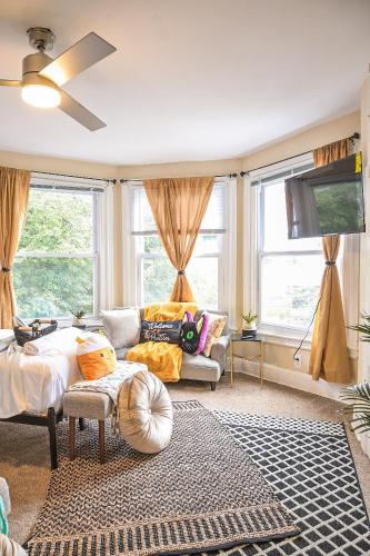 a living room with a bed and a couch at Chic 4BR Dwelling with Backyard in Philadelphia in Philadelphia