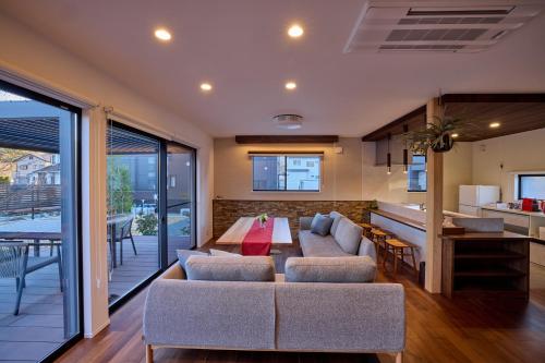 a living room with a couch and a table at 富士ガーデンビュー　空と庭と in Fujikawaguchiko