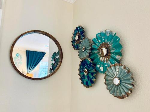 a mirror and some blue paper flowers on a wall at The Chadwick in San Diego