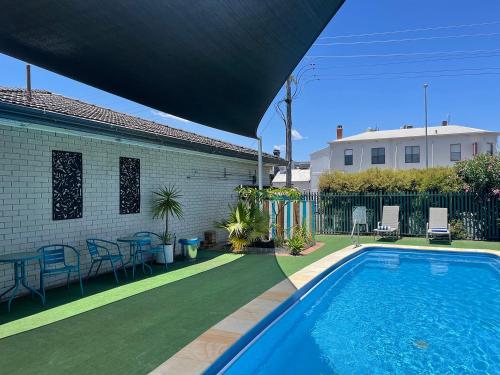 a swimming pool in the backyard of a house at Adelong Motel in Narrabri