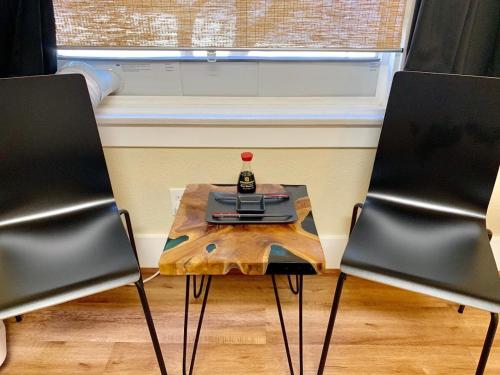 a table with a bottle on it between two chairs at The Chadwick in San Diego