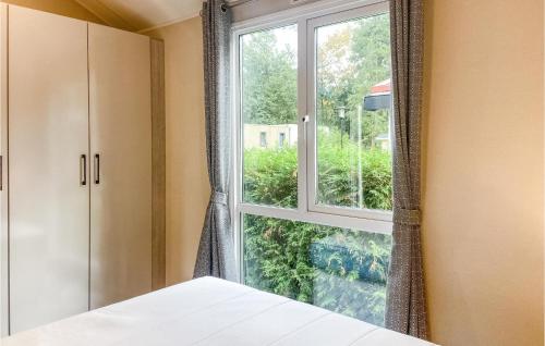 a bedroom with a window and a bed at 2 Bedroom Lovely stacaravan In Harderwijk in Harderwijk