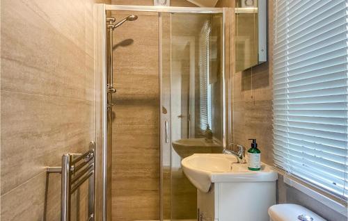 a bathroom with a shower and a toilet and a sink at 2 Bedroom Lovely stacaravan In Harderwijk in Harderwijk