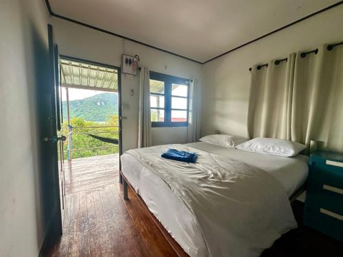 a bedroom with a bed and a large window at Hilltop view - Phi Phi in Phi Phi Don