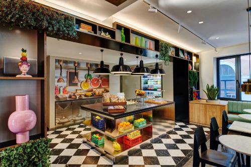a restaurant with a checkered floor at citizenM Rome Isola Tiberina in Rome