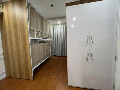 a room with a closet with white cabinets at Homestay Vincom Trần Duy Hưng Female Dorm in Hanoi