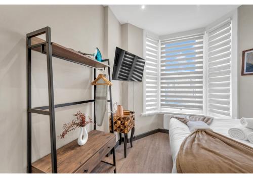 a bedroom with a bunk bed and a window at Escape the Ordinary: Cozy and Charming Studio in London