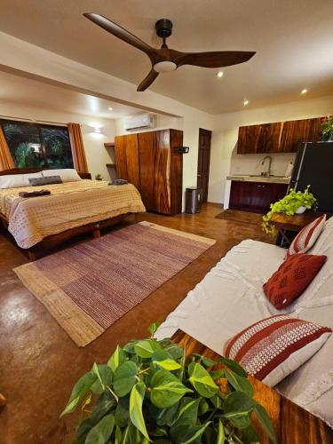 a bedroom with a bed and a ceiling fan at Balu Retreat Center in Playa Junquillal