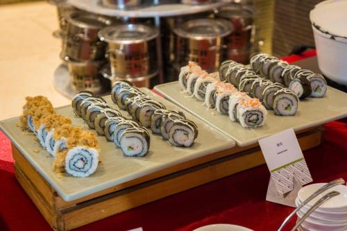 a bunch of sushi sitting on a table at DoubleTree by Hilton Guangzhou - Canton Fair Free Shuttle Bus & Exhibition Registration Service in Guangzhou