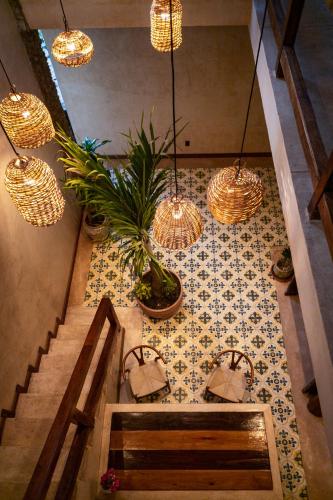 a room with a staircase with potted plants and lights at Mero Mero Hotel in El Cuyo