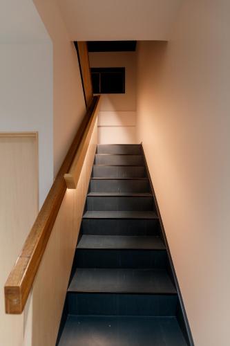 a staircase in a building with a stair case at ROOM design hotel in Nanao