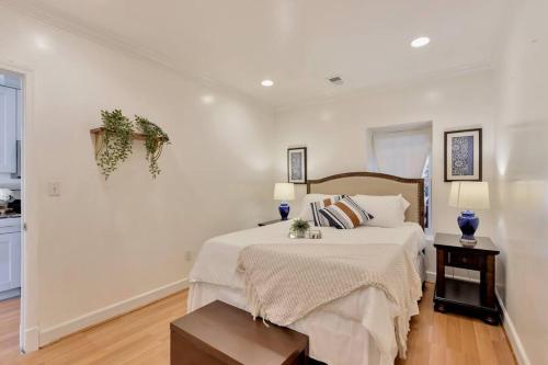 um quarto branco com uma cama e 2 candeeiros em DC A lovely urban oasis condo em Washington
