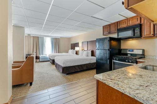 um quarto de hotel com duas camas e uma cozinha em Comfort Inn & Suites em Triadelphia