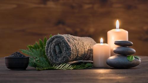 a group of candles and a towel and a pile of stones at InterContinental Dhaka by IHG in Dhaka