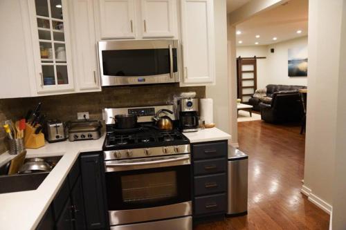 a kitchen with a stove and a microwave at Nice and cozy. Sleeps 5. in Chicago