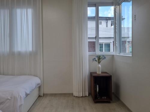 a bedroom with a bed and a window at hongdae Gangnam line 2 st 1 min in Seoul