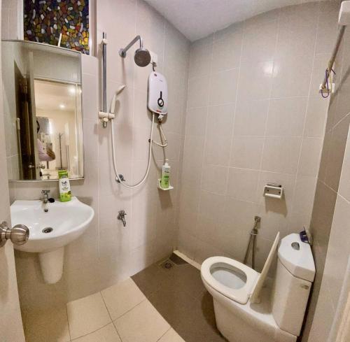 y baño con aseo blanco y lavamanos. en Moonstone studio D'Perdana Apartment, en Kota Bharu