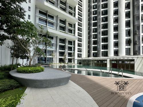 a courtyard with a fountain in front of two tall buildings at Borneotel The Shore KK by CHG in Kota Kinabalu
