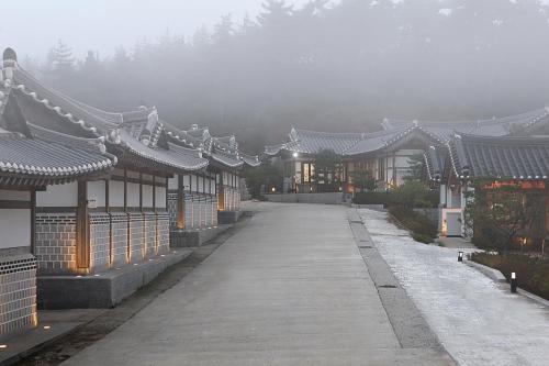 a walkway in an asian village with buildings at Hotelarrive Taean Tiann HanokBeachResort in Taean