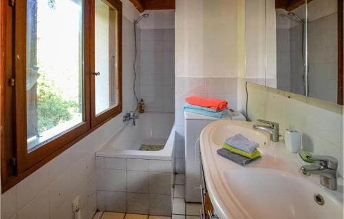 baño con lavabo, bañera y ventana en Cozy Home In Mercuer With House A Panoramic View, en Mercuer
