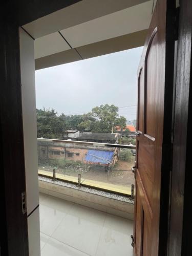 a window in a room with a view of a train at Shrinath Palace in Deoghar