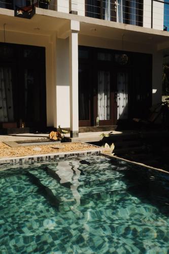 a swimming pool in front of a building at The Jini House in Ahangama