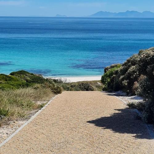 a path leading to a beach with the ocean at Lighthouse Villa Romansbaai in Gansbaai