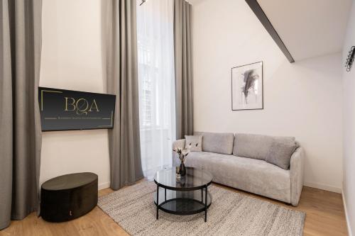 uma sala de estar com um sofá e uma mesa em E56 Queen's Boutique Apartment,best Location by BQA em Budapeste