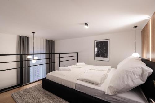 a bedroom with a large white bed with white pillows at E56 - Grand Boulevard Heritage Residence - Best Location by BQA in Budapest