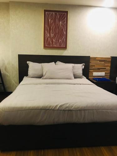a bedroom with a large bed with white pillows at FirIzzkey Studio in Kota Bharu