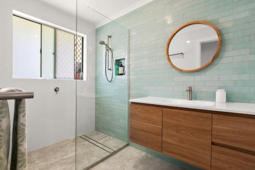 a bathroom with a sink and a mirror at Browning Boulevard 9, Battery Hill in Caloundra